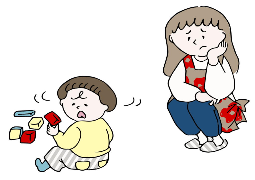 積み木を崩して困る子供と落ち込む母親